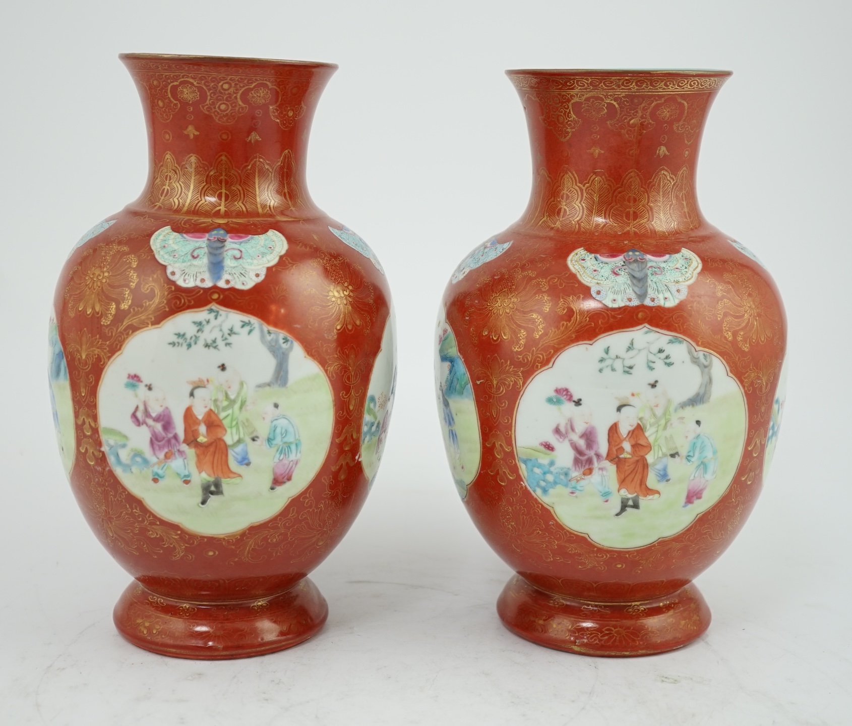 A pair of Chinese coral ground ‘boys’ vases, Jiaqing period (1796-1820)